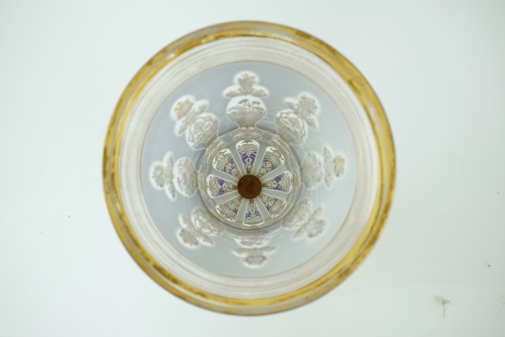 A tall 19th century Bohemian blue and white overlaid gilt and enamel decorated vase in the manner of Moser